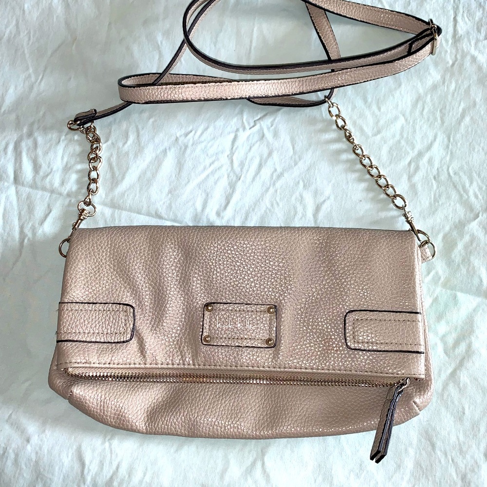Nicole Miller purse. Zips and folds over. Animal print lining. Shoulder strap.